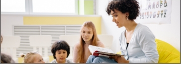 Teacher reads a book for pupils